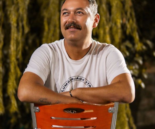 Smiling person enjoying a moment of calm outdoors.